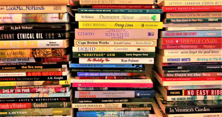 The photograph displays a huge selection of paperback and hardcover books available, including many 1st Edition, Signed by Author, Rare copies, BC subjects, Canadiana, Politics, Biographical, and many more subjects!