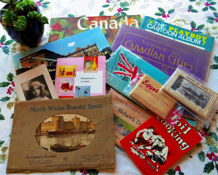 Photograph displays an assortment of ephemera, which is older printed paper materials other than books, including postcards, printed cards, letters, brochures, pamplets, maps, travel brochures, picture albums, hand tinted souvenir cards, and much more!