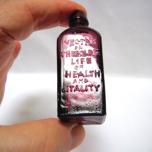 Vintage Miniature Purple Glass Bottle: "STRAUB HULLER'S TREE OF LIFE ELIXER SINCE 1880"