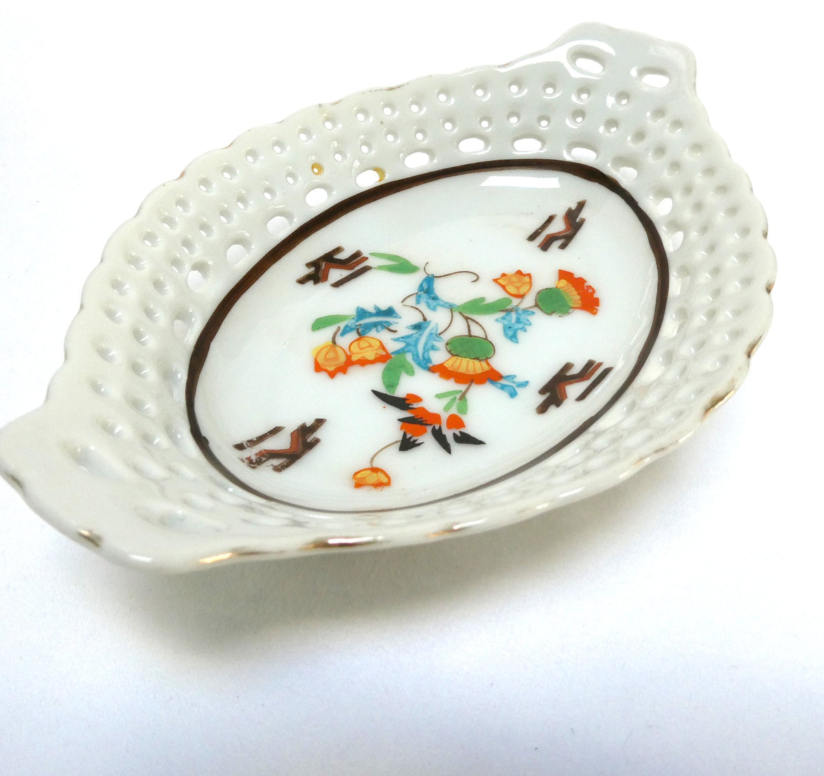 Vintage reticulated porcelain trinket dish featuring a delicate, pierced lattice rim and integrated small handles from Japan