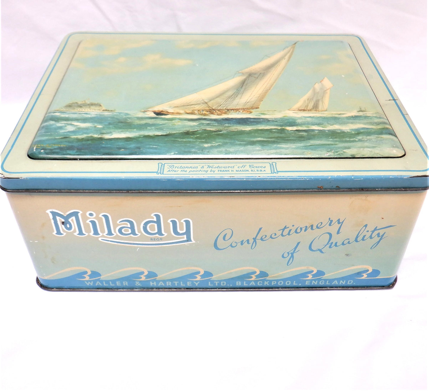 An Antique Milady Confectionery Tin displaying the famous painting by Frank H. Mason: 'BRITANNIA & WESTWARD OFF COWES'