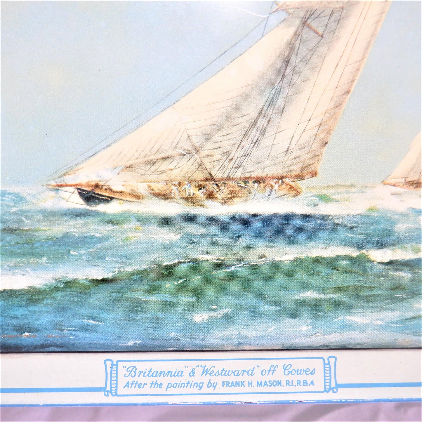 An Antique Milady Confectionery Tin displaying the famous painting by Frank H. Mason: 'BRITANNIA & WESTWARD OFF COWES'