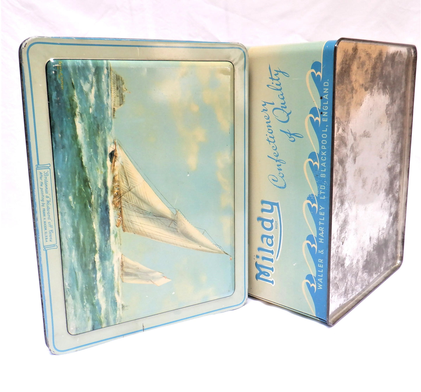 An Antique Milady Confectionery Tin displaying the famous painting by Frank H. Mason: 'BRITANNIA & WESTWARD OFF COWES'