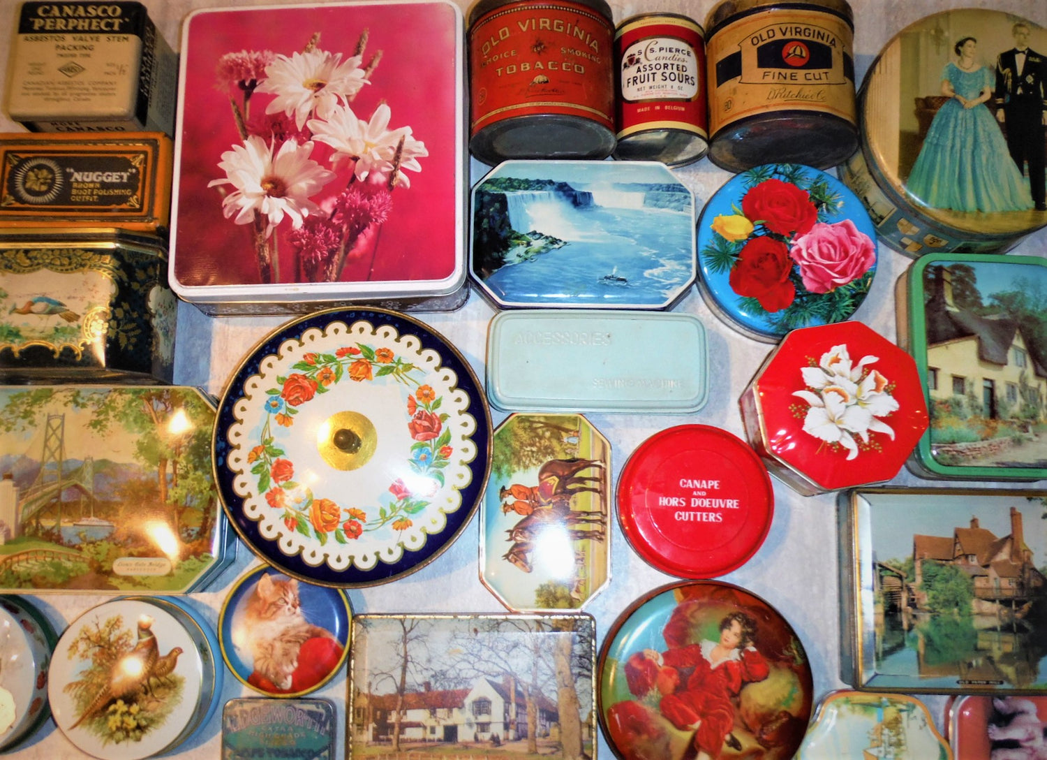 The photo image is of various vintage tin cans and containers, including royalty tins, souvenir tins, biscuit tins, candy tins, and many other varieties of collectible tin can containers!
