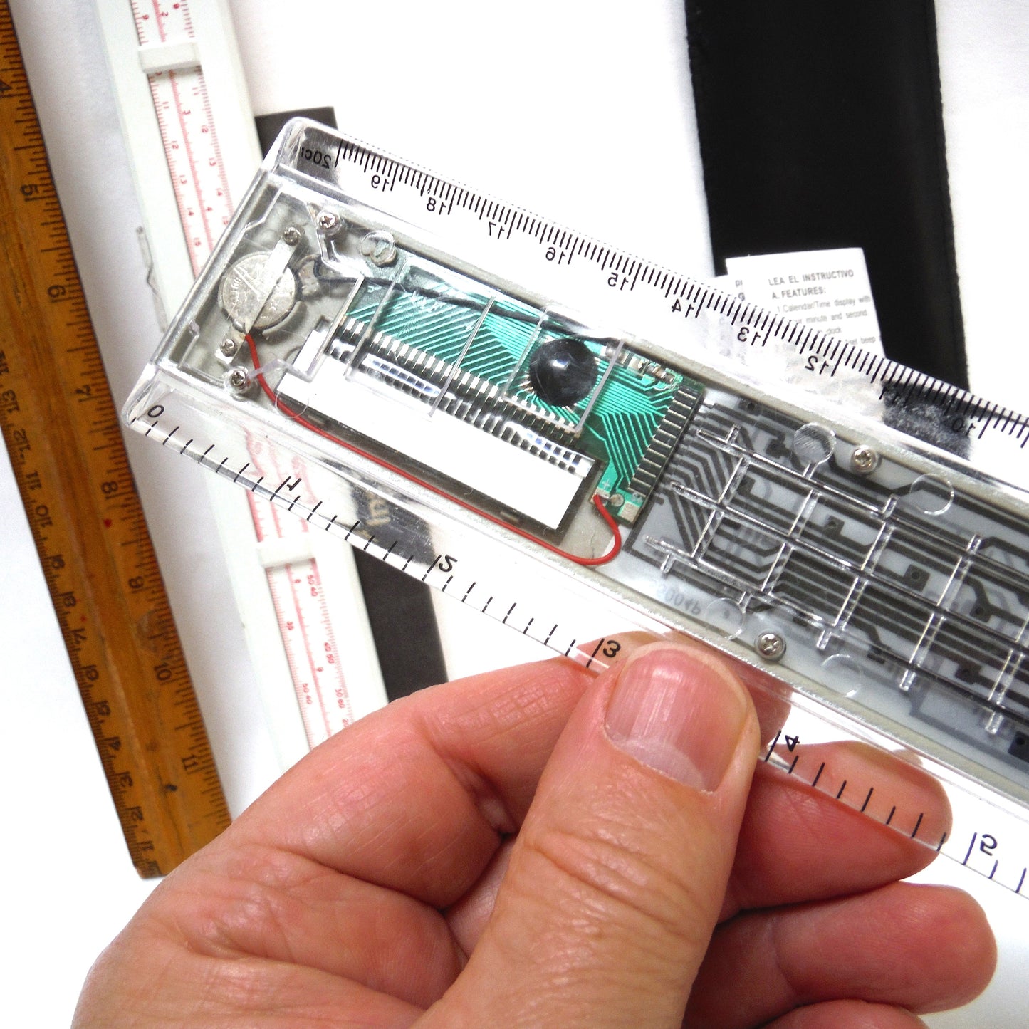 TRIO OF MEASURING DEVICES THROUGH THE AGES: Wood Ruler, Slide Ruler, and Electronic Ruler