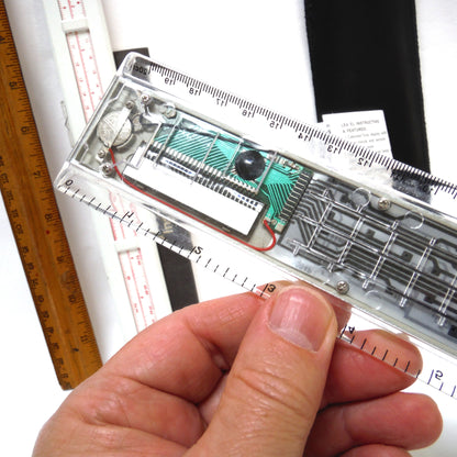 TRIO OF MEASURING DEVICES THROUGH THE AGES: Wood Ruler, Slide Ruler, and Electronic Ruler
