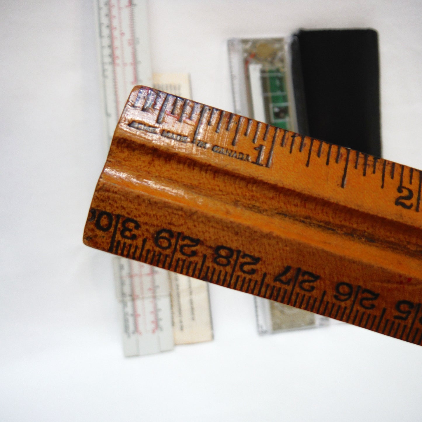 TRIO OF MEASURING DEVICES THROUGH THE AGES: Wood Ruler, Slide Ruler, and Electronic Ruler