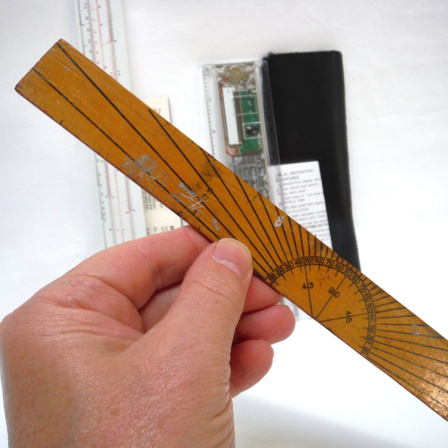 TRIO OF MEASURING DEVICES THROUGH THE AGES: Wood Ruler, Slide Ruler, and Electronic Ruler