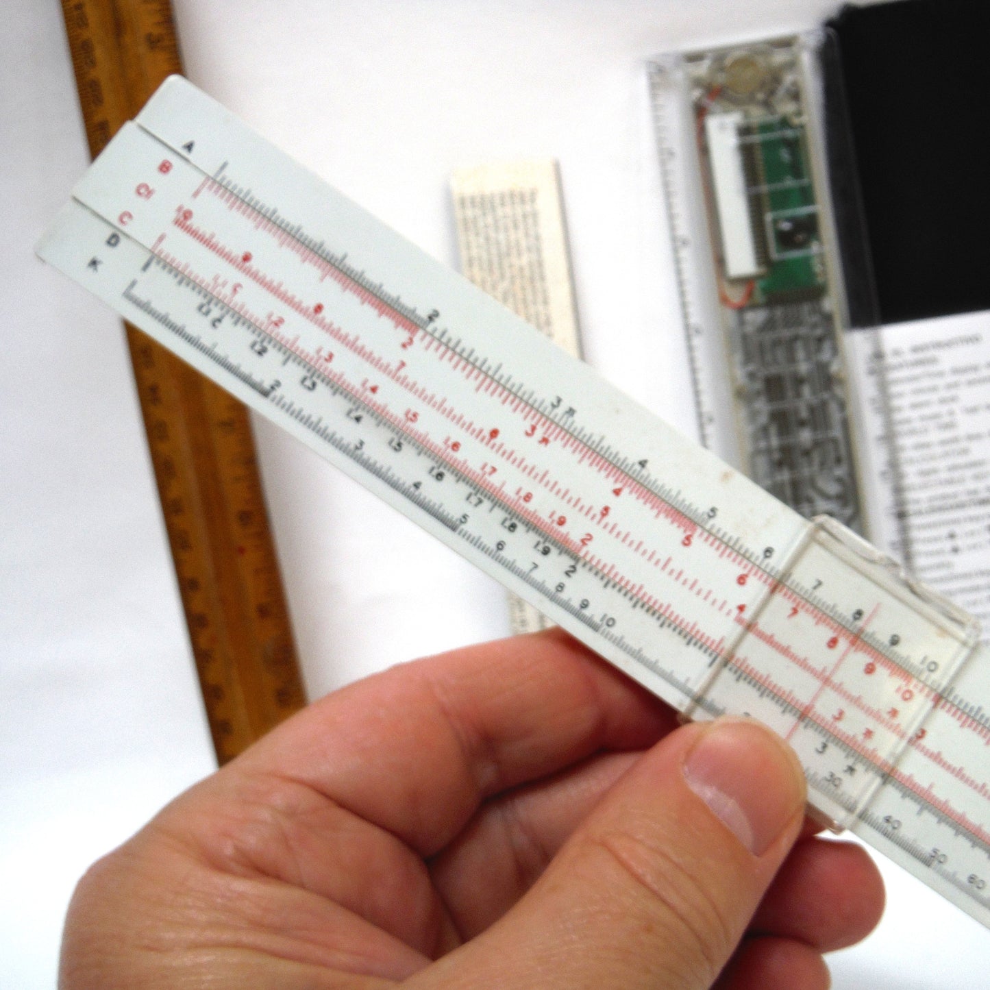 TRIO OF MEASURING DEVICES THROUGH THE AGES: Wood Ruler, Slide Ruler, and Electronic Ruler