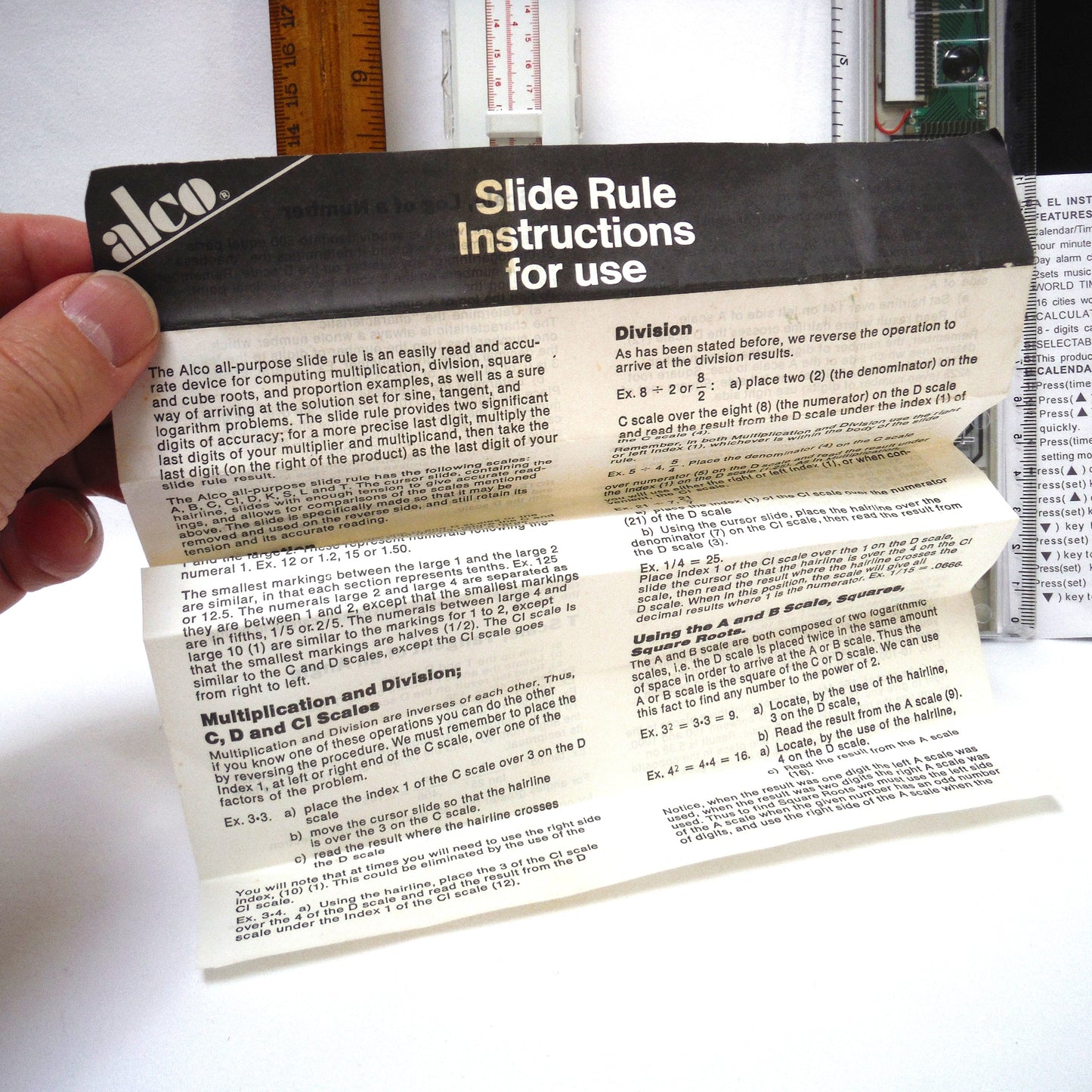 TRIO OF MEASURING DEVICES THROUGH THE AGES: Wood Ruler, Slide Ruler, and Electronic Ruler