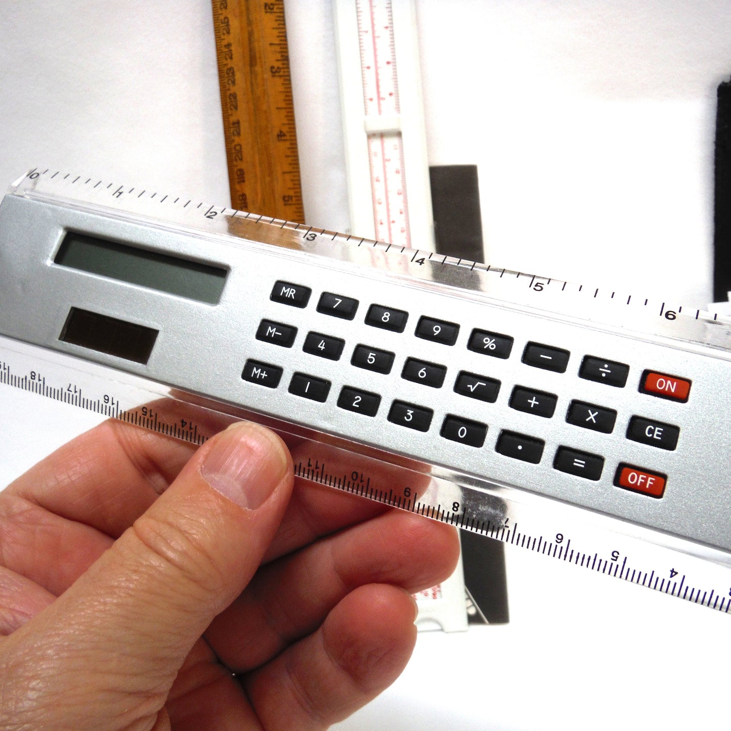 TRIO OF MEASURING DEVICES THROUGH THE AGES: Wood Ruler, Slide Ruler, and Electronic Ruler