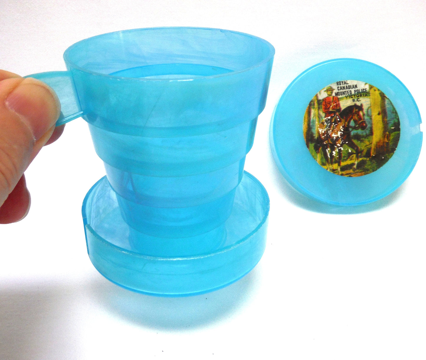 Vintage Portable Collapsing Travel Mug in Turquoise Blue: ROYAL CANADIAN MOUNTED POLICE, by "Collaps-A-Mug" of Hong Kong