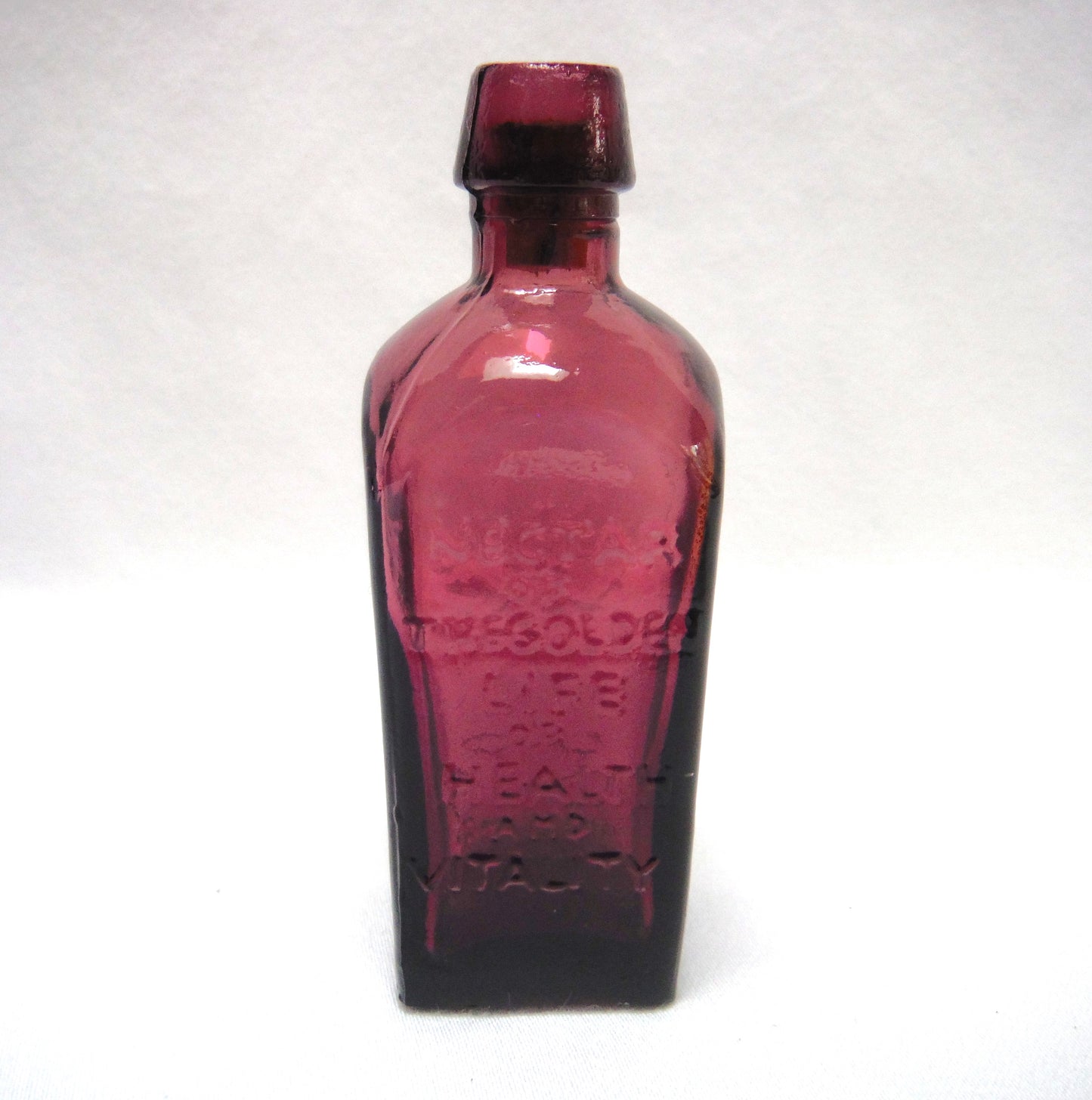 Vintage Miniature Purple Glass Bottle: "STRAUB HULLER'S TREE OF LIFE ELIXER SINCE 1880"