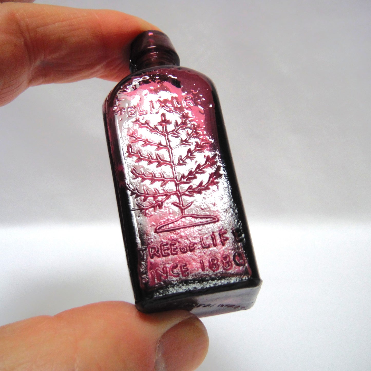 Vintage Miniature Purple Glass Bottle: "STRAUB HULLER'S TREE OF LIFE ELIXER SINCE 1880"