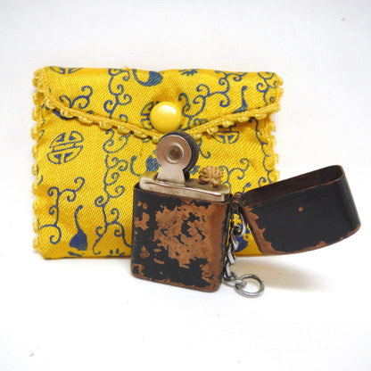 Antique Cigarette Lighter and A Yellow Asian-Style Silk Bag