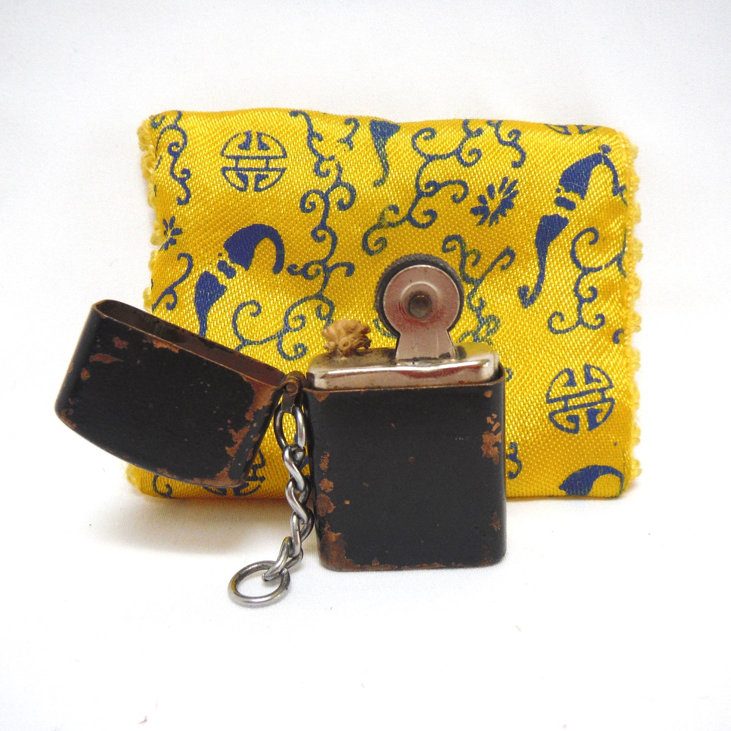 Antique Cigarette Lighter and A Yellow Asian-Style Silk Bag