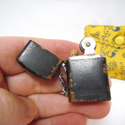 Antique Cigarette Lighter and A Yellow Asian-Style Silk Bag