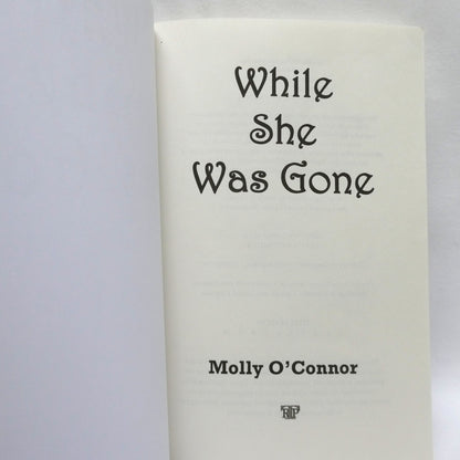 WHILE SHE WAS GONE, A Novel by Molly O'Connor (1st Ed. SIGNED)