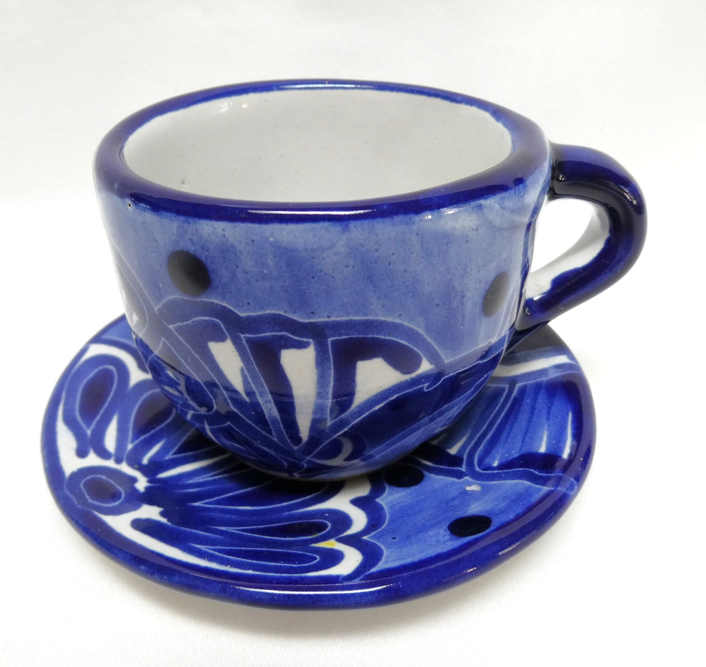 Hand-painted blue and white ceramic espresso cup and saucer set featuring traditional Mexican Talavera-style floral patterns