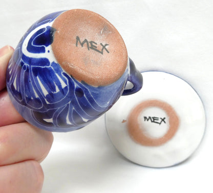 Hand-painted blue and white ceramic espresso cup and saucer set featuring traditional Mexican Talavera-style floral patterns