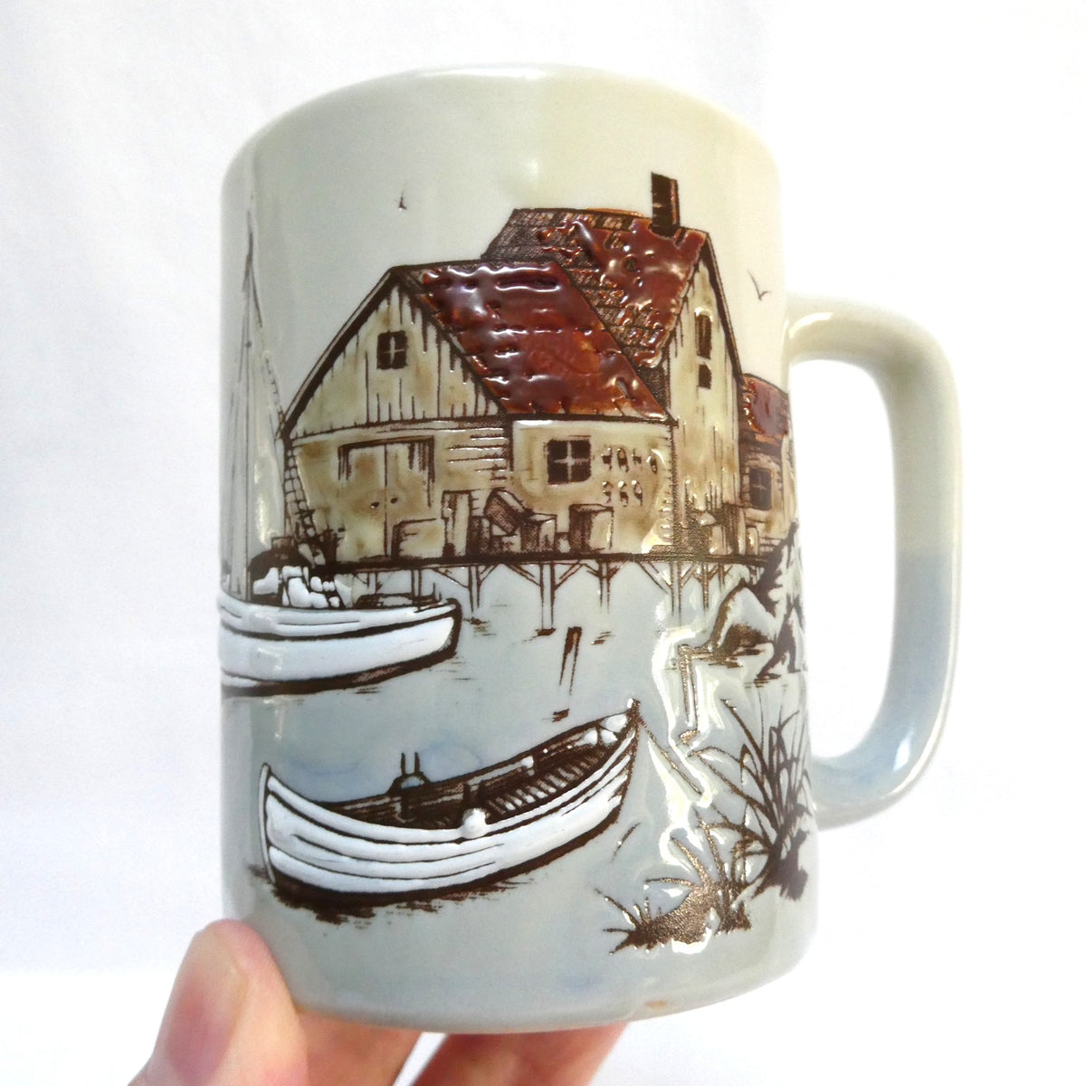 Otagiri Japanese Stoneware Coffee Mug Featuring an Embossed and Hand-Painted Canadian Maritime Coastal Fishing Village and Boat Scene