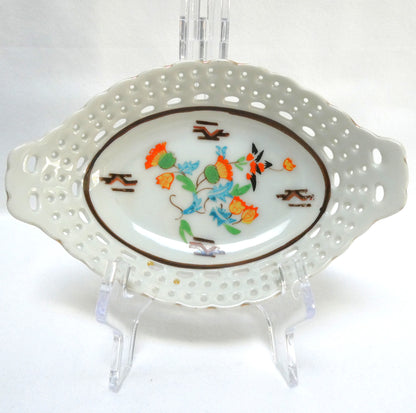 Vintage reticulated porcelain trinket dish featuring a delicate, pierced lattice rim and integrated small handles from Japan