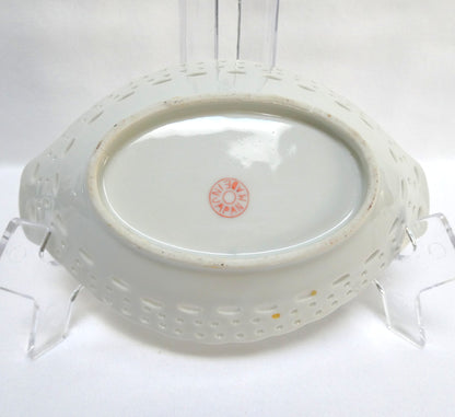 Vintage reticulated porcelain trinket dish featuring a delicate, pierced lattice rim and integrated small handles from Japan