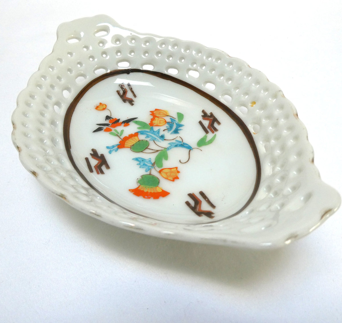Vintage reticulated porcelain trinket dish featuring a delicate, pierced lattice rim and integrated small handles from Japan
