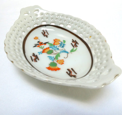Vintage reticulated porcelain trinket dish featuring a delicate, pierced lattice rim and integrated small handles from Japan