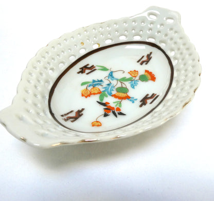 Vintage reticulated porcelain trinket dish featuring a delicate, pierced lattice rim and integrated small handles from Japan